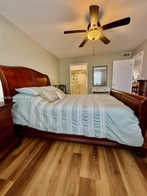 2981 North Nob Hill Road, Unit 306 Sunrise, FL 33322 - Photo 19 of 34 a bedroom with a bed and a chandelier