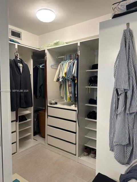 2981 North Nob Hill Road, Unit 306 Sunrise, FL 33322 - Photo 20 of 34 a view of walk in closet with clothes and shoes