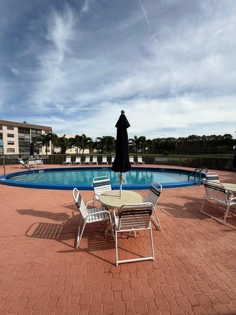 2981 North Nob Hill Road, Unit 306 Sunrise, FL 33322 - Photo 24 of 34 a lawn chairs sitting on a terrace with a lake view