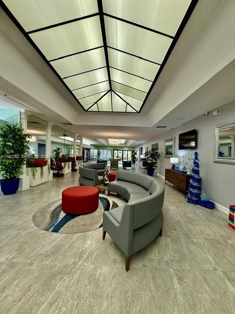 2981 North Nob Hill Road, Unit 306 Sunrise, FL 33322 - Photo 29 of 34 a living room with furniture a cars parked and a garage