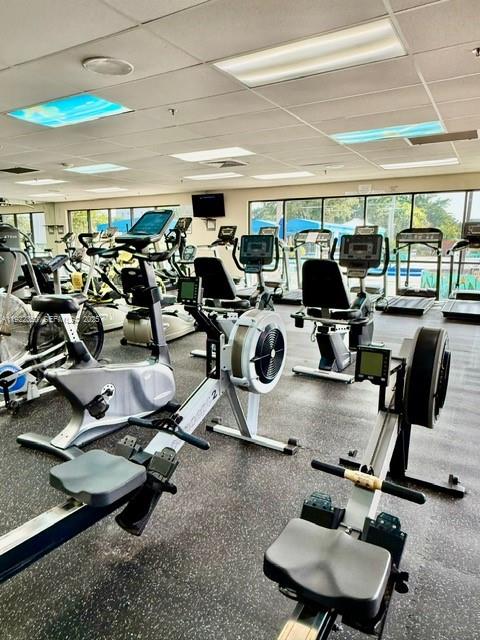 2981 North Nob Hill Road, Unit 306 Sunrise, FL 33322 - Photo 30 of 34 a room with gym equipment and a large window