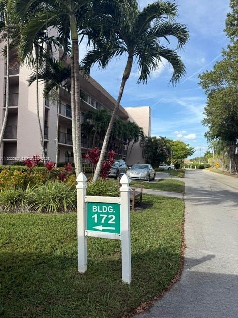 2981 North Nob Hill Road, Unit 306 Sunrise, FL 33322 - Photo 3 of 34 a view of a garden with a bench and potted plants