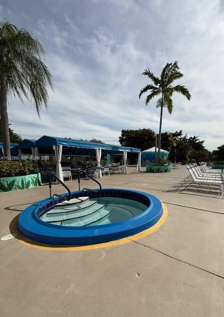 2981 North Nob Hill Road, Unit 306 Sunrise, FL 33322 - Photo 33 of 34 a swimming pool with outdoor seating yard and barbeque oven