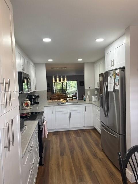 2981 North Nob Hill Road, Unit 306 Sunrise, FL 33322 - Photo 4 of 34 a kitchen with stainless steel appliances a refrigerator sink and microwave