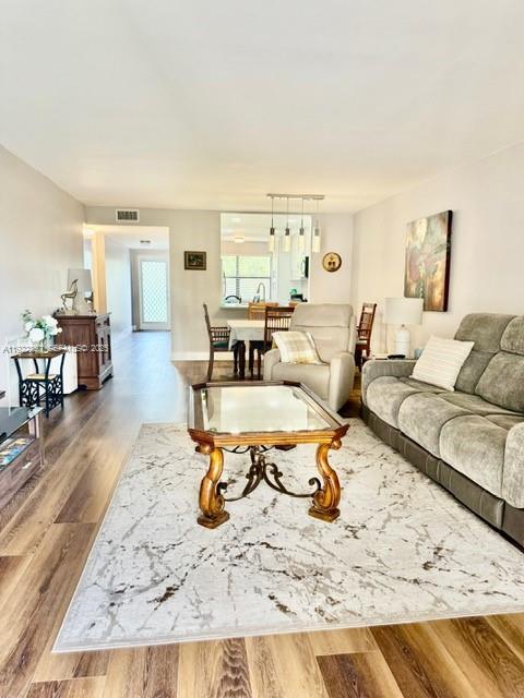 2981 North Nob Hill Road, Unit 306 Sunrise, FL 33322 - Photo 8 of 34 a living room with furniture and a table