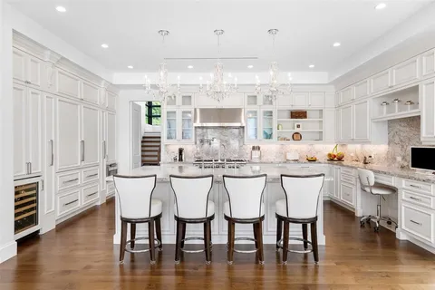 a living room with furniture large window and a table