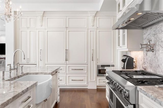 a dining room with furniture large windows and a chandelier