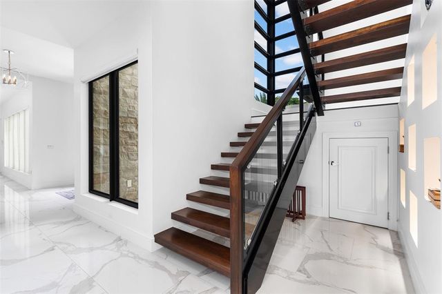 a living room with furniture and floor to ceiling windows