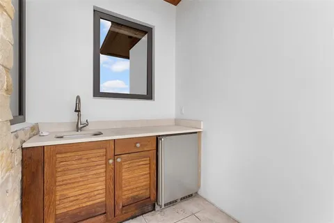 a kitchen with granite countertop a sink and cabinets