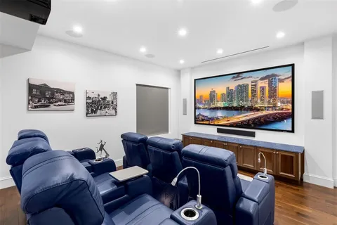 a backyard of a house with table and chairs potted plants