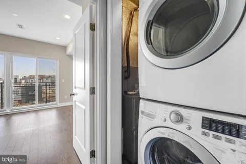 a view of a hallway with washer and dryer