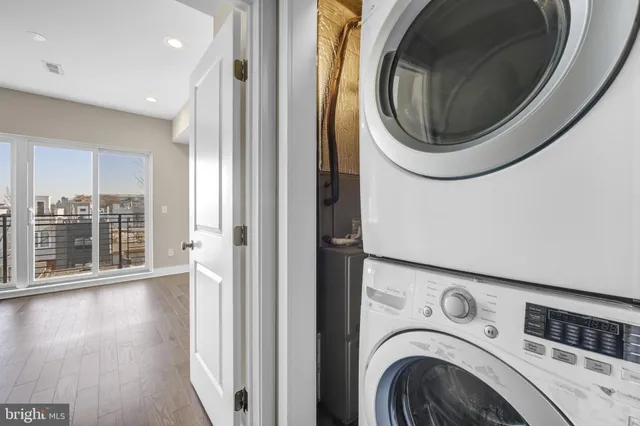 a view of a hallway with washer and dryer
