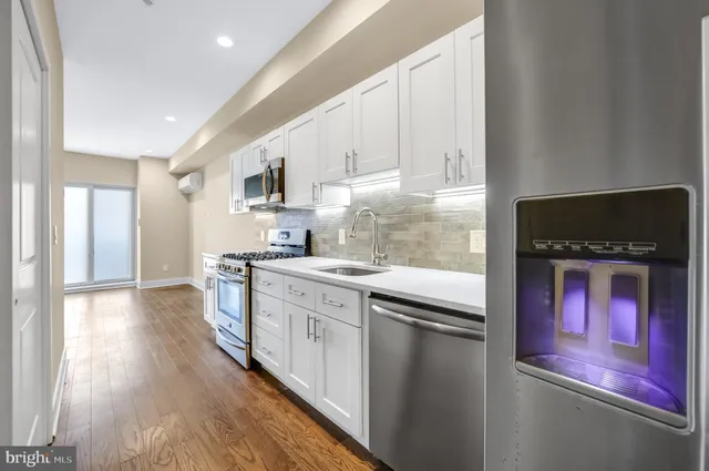 a kitchen with stainless steel appliances granite countertop a stove and a refrigerator