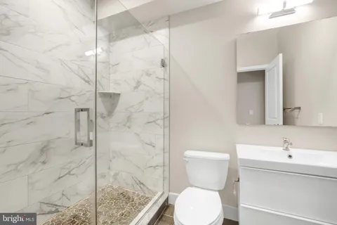 a bathroom with a sink toilet and shower