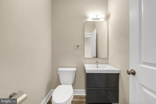 a bathroom with a toilet sink and mirror
