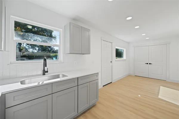 a kitchen with a sink and cabinets