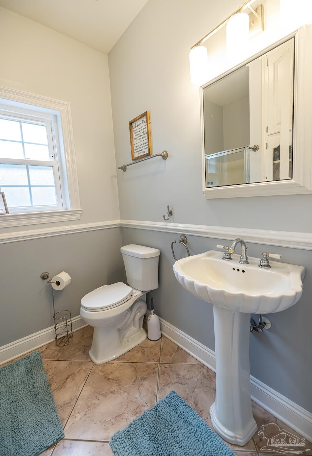 5013 Roland Road Pace, FL 32571 - Photo 14 of 30 a bathroom with a sink toilet and mirror