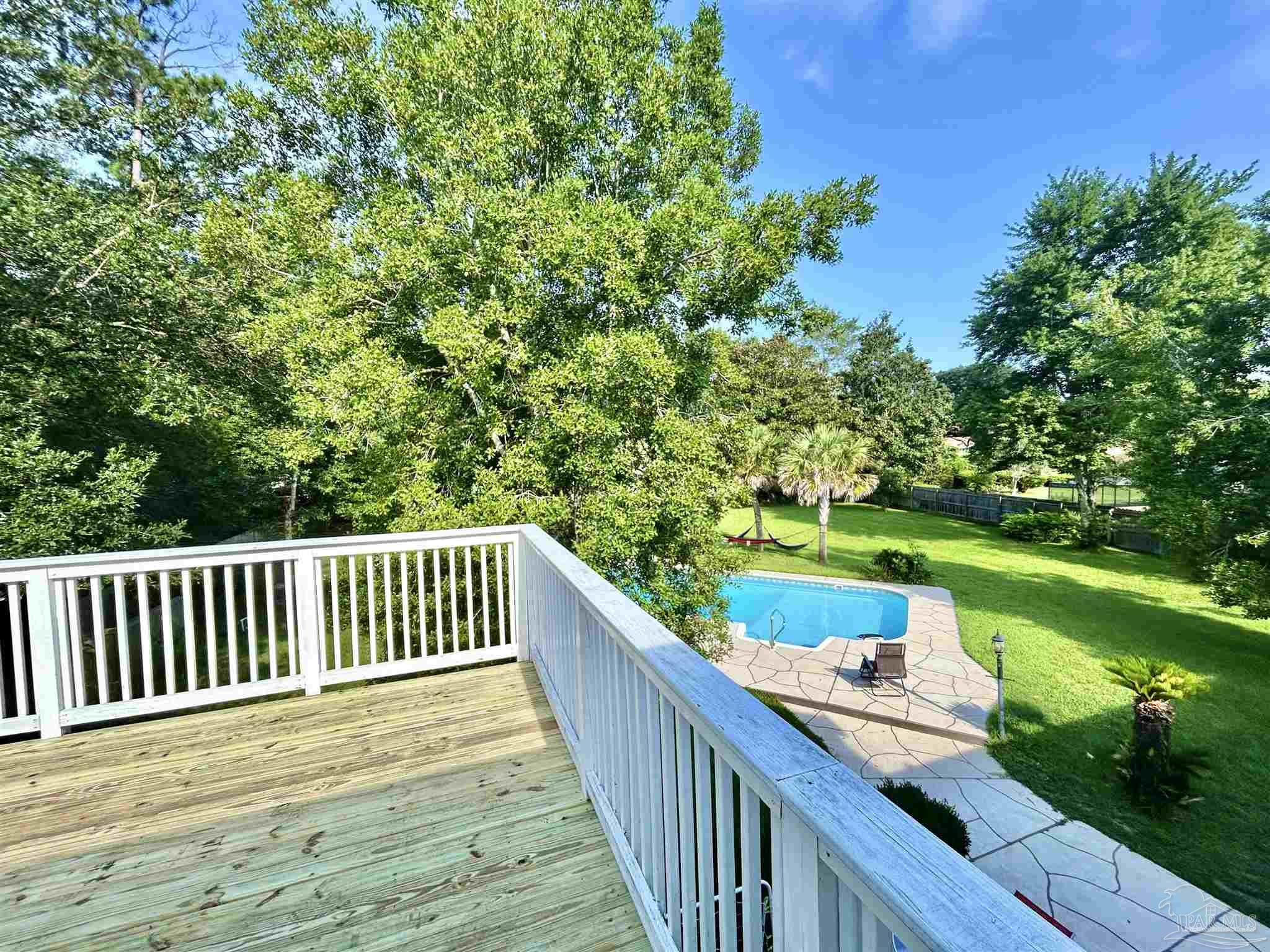 5013 Roland Road Pace, FL 32571 - Photo 30 of 30 a balcony with wooden floor and yard in the back