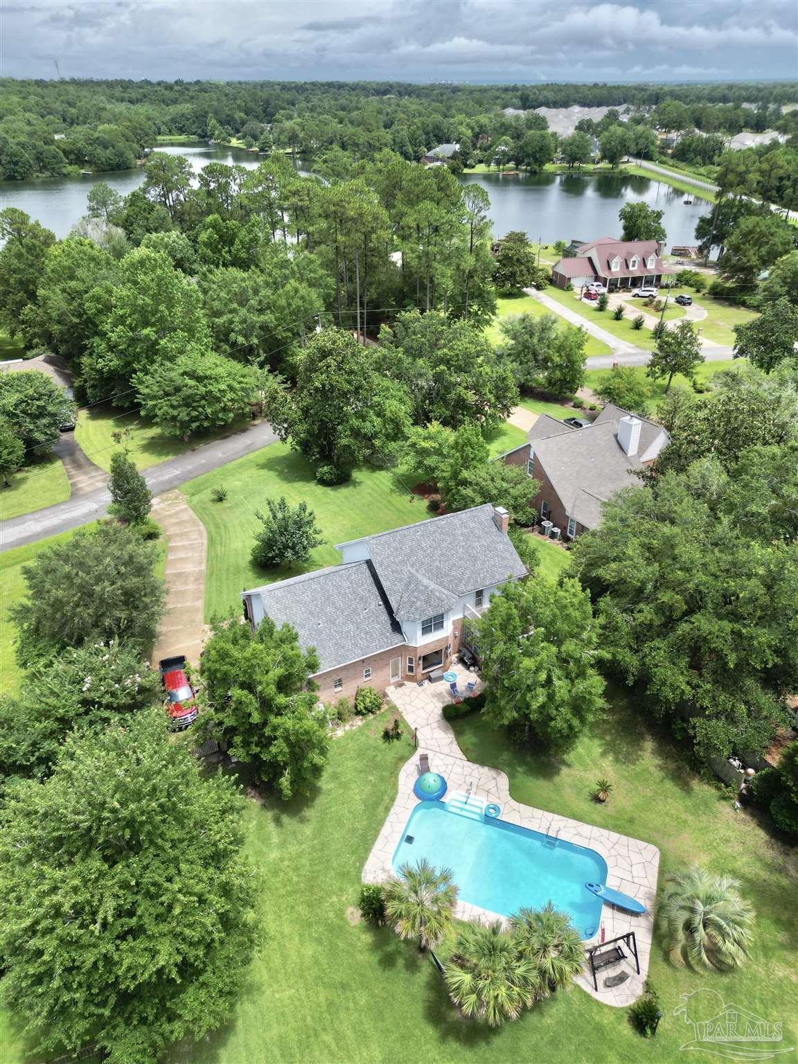 5013 Roland Road Pace, FL 32571 - Photo 3 of 30 an aerial view of a house with a garden and lake view