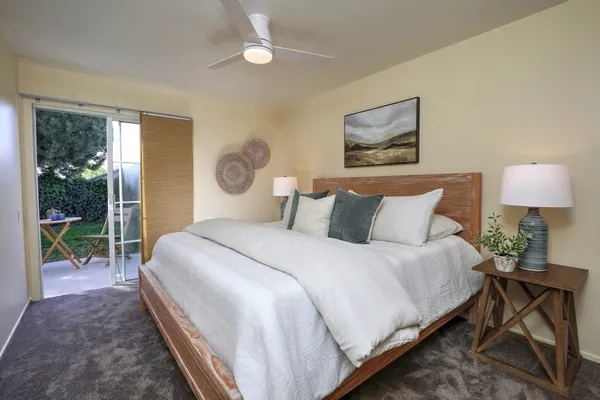 a bedroom with bed and a window