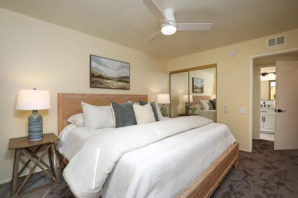 a bedroom with a bed and a lamp