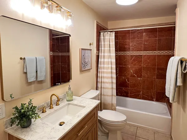 a bathroom with a sink toilet and shower