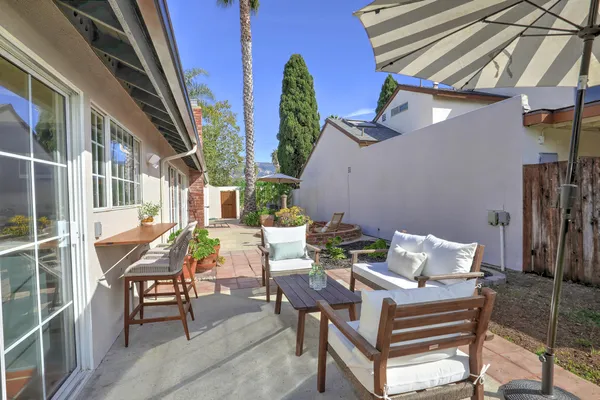 a view of backyard with outdoor seating and stairs