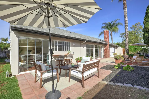 a view of a house with backyard porch and sitting area