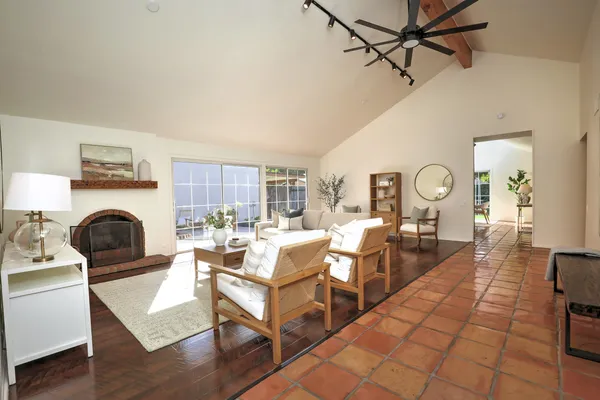a living room with fireplace furniture and a wooden floor
