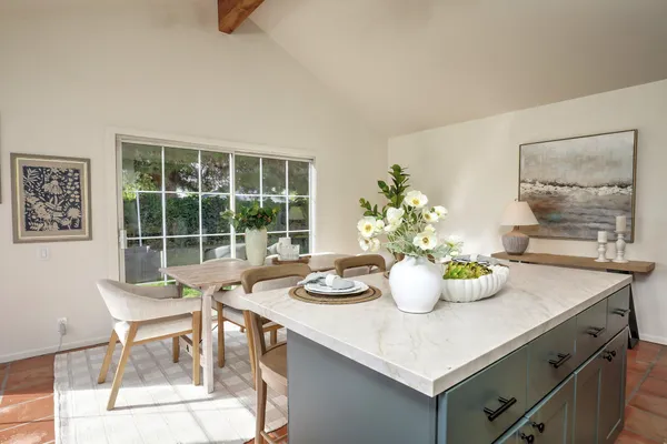 a dining room with furniture and window