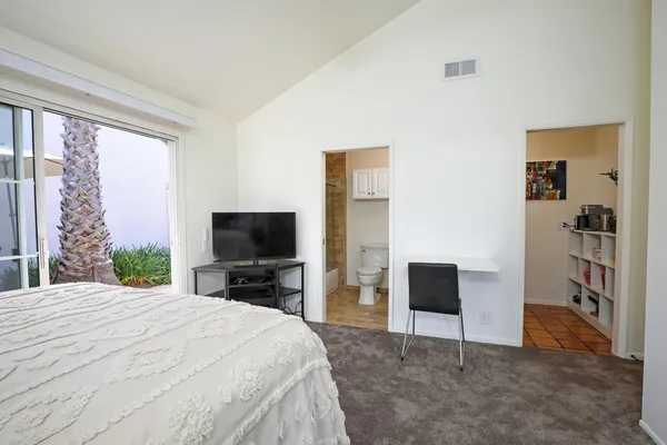 a bedroom with a bed and a television in it