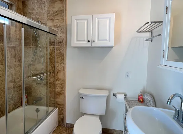 a bathroom with a sink a toilet and bathtub