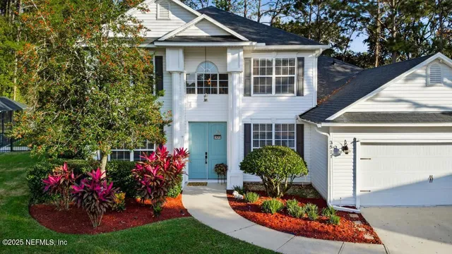 a view of a bedroom with a floor to ceiling window and a yard