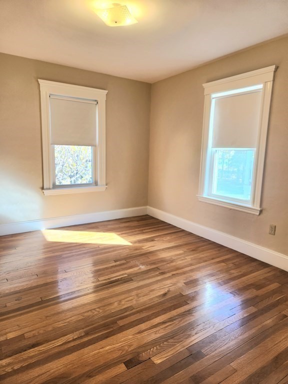 25 Glendower Road, Unit 2 Boston, MA 02131 - Photo 12 of 17 a view of an empty room with wooden floor and a window