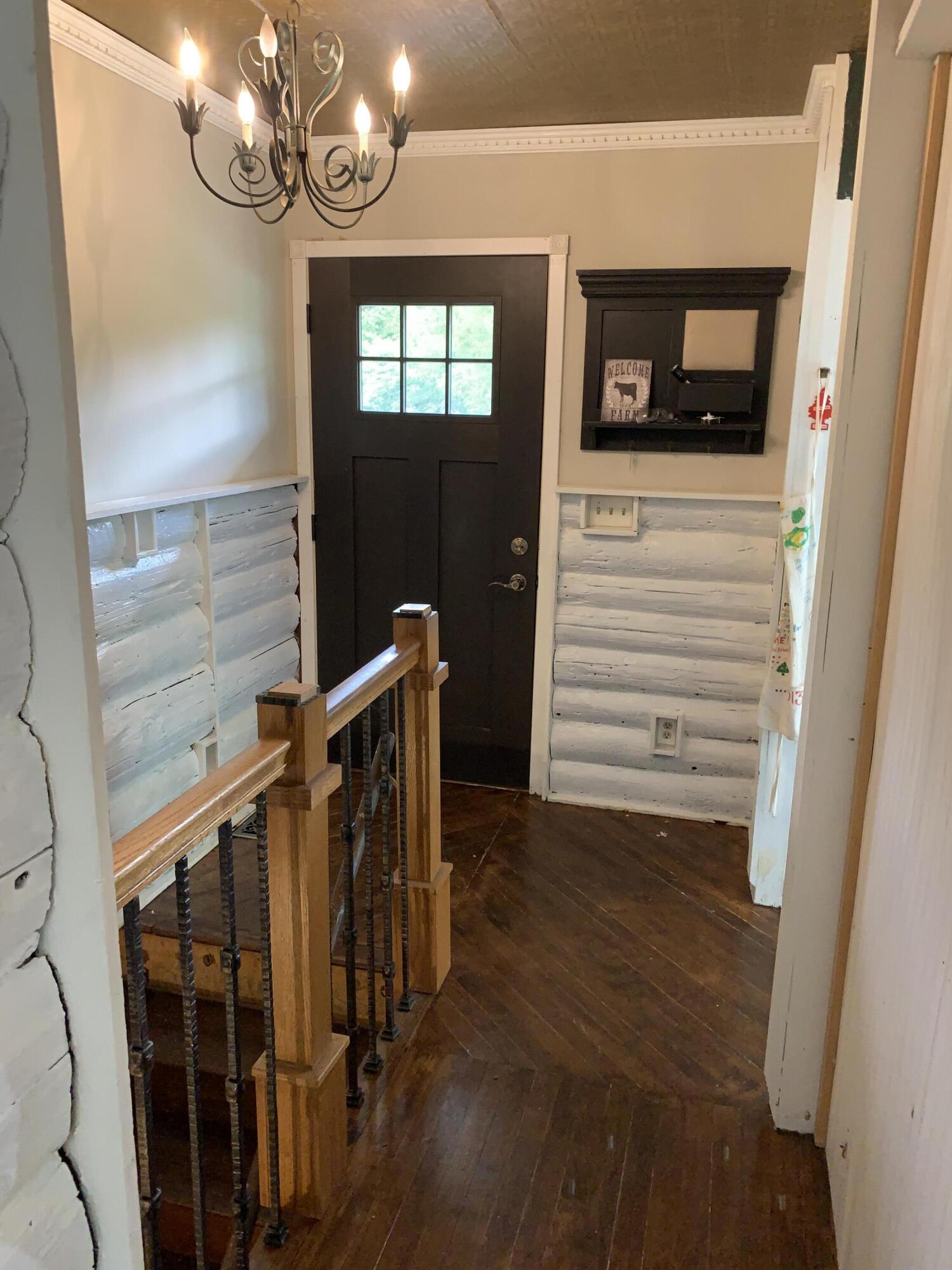 48 East Division Road Valparaiso, IN 46383 - Photo 2 of 13 a view of a hallway with wooden floor and staircase
