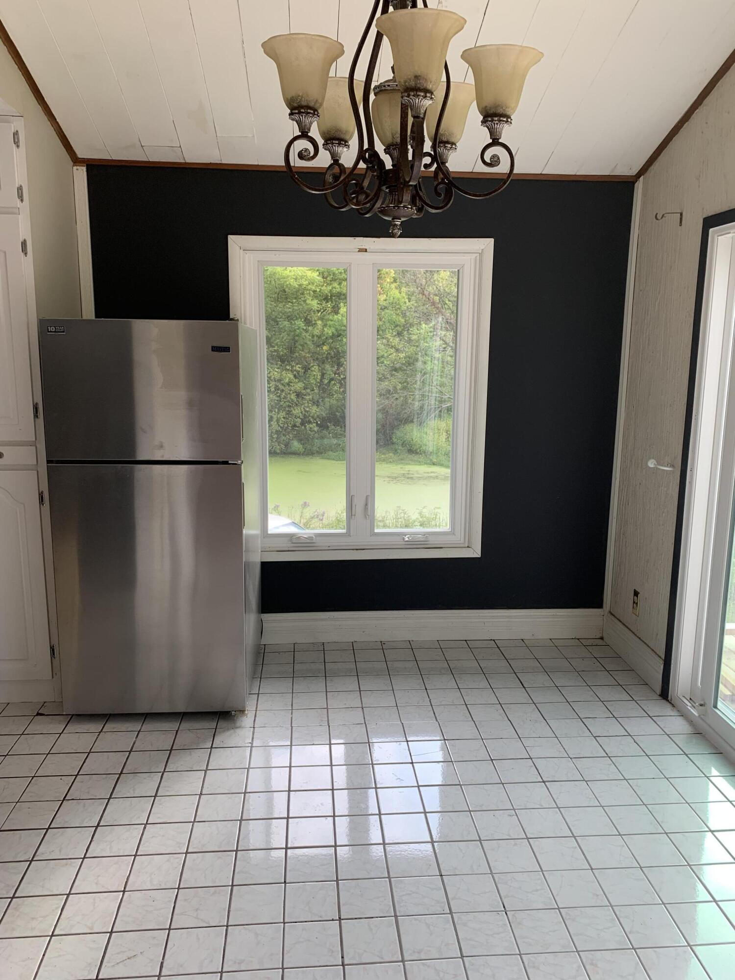 48 East Division Road Valparaiso, IN 46383 - Photo 4 of 13 a view of kitchen with furniture and refrigerator