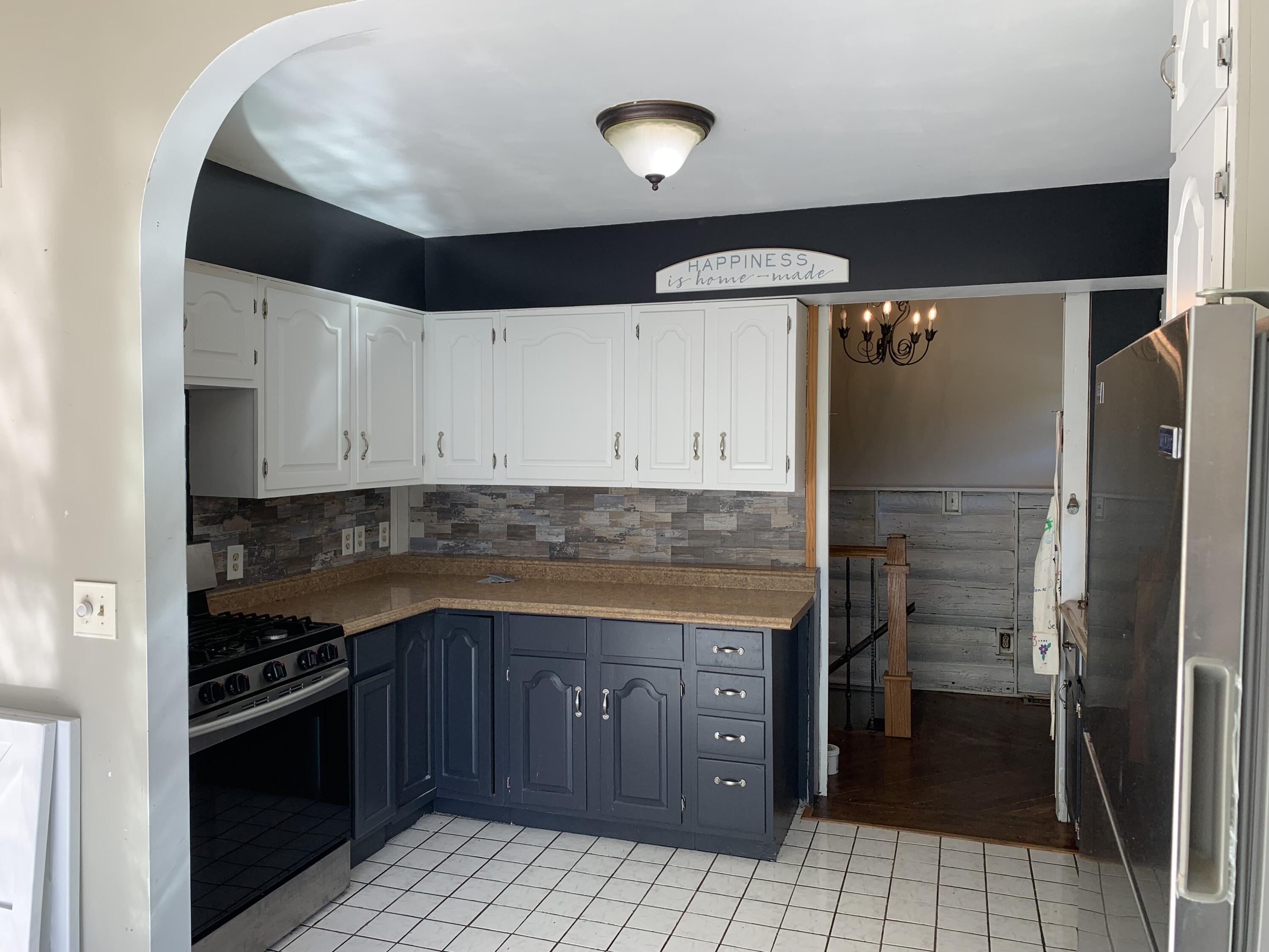 48 East Division Road Valparaiso, IN 46383 - Photo 5 of 13 a kitchen with a sink and a refrigerator