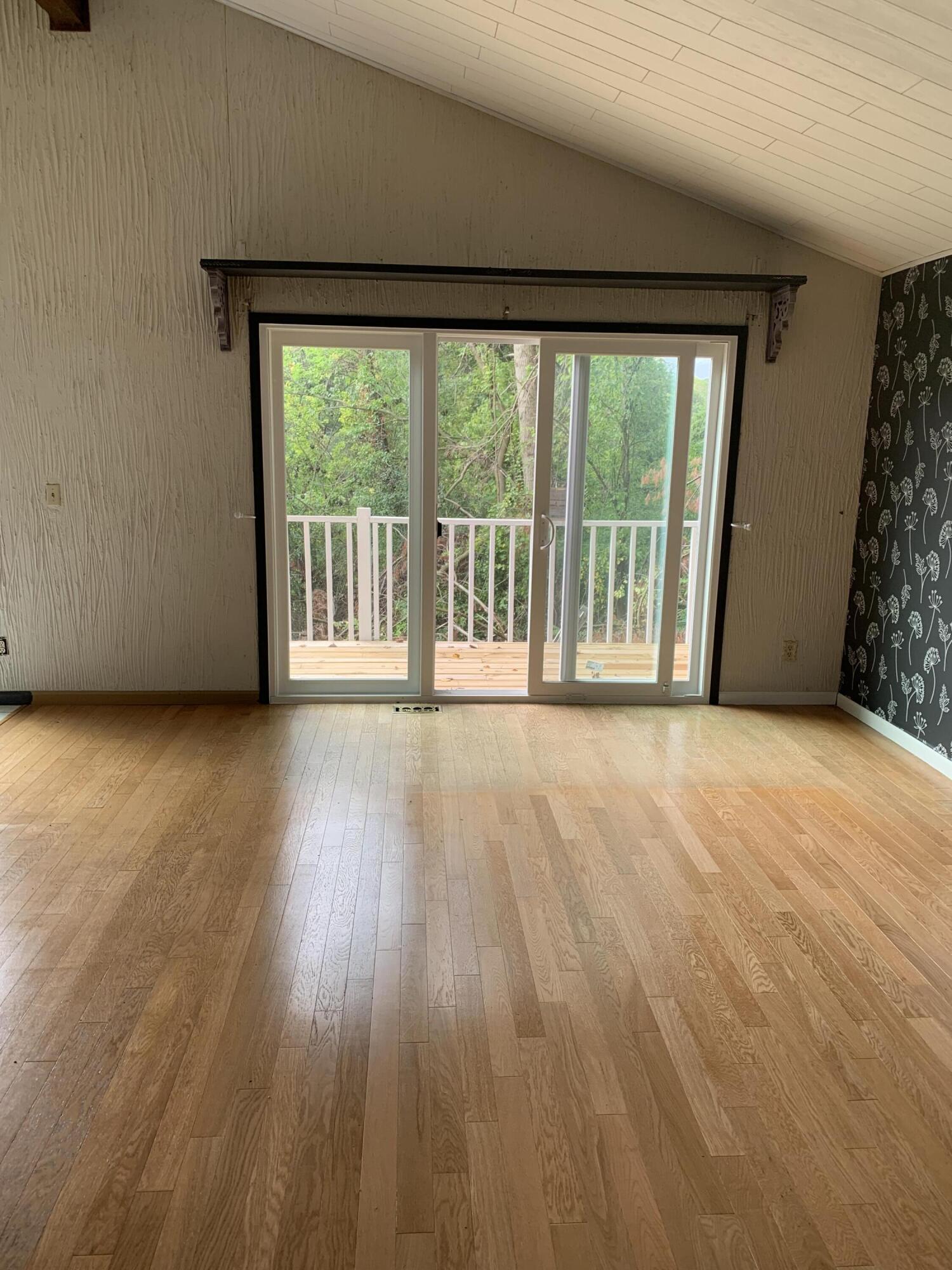 48 East Division Road Valparaiso, IN 46383 - Photo 8 of 13 a view of an empty room with wooden floor and a window