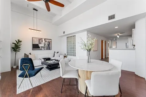 a dining room with furniture and wooden floor