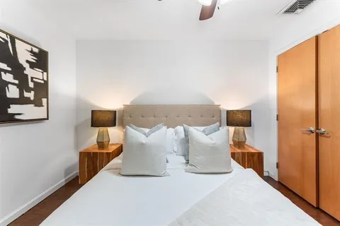 a bed room with a bed and a night stand