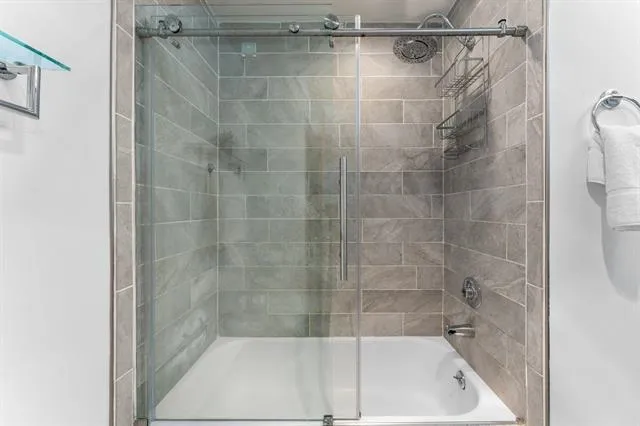 a bathroom with a shower and a bathtub