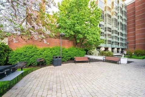 a view of a patio with a table and chairs under an umbrella