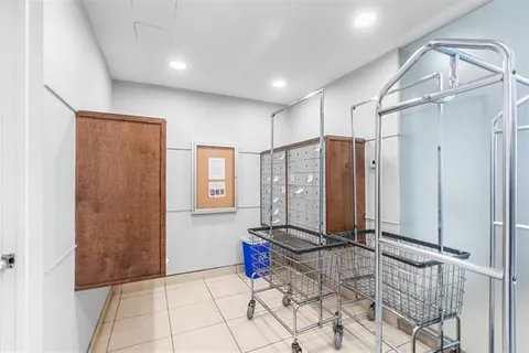 a view of a hallway with bathroom view and mirror