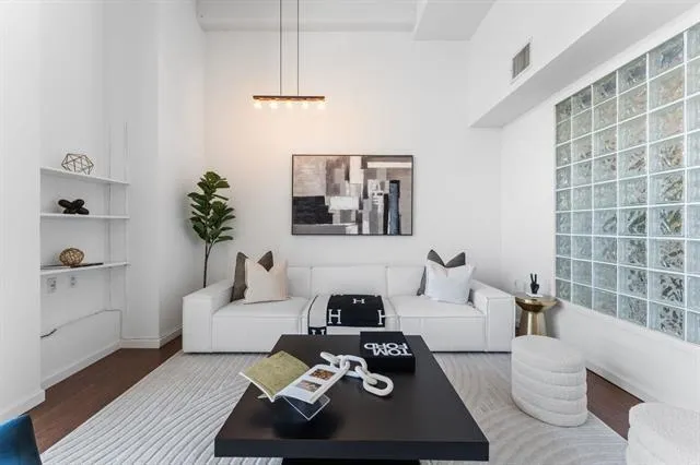 a living room with furniture and a wooden floor