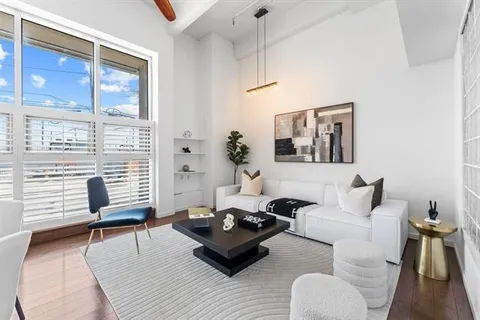 a living room with furniture and wooden floor