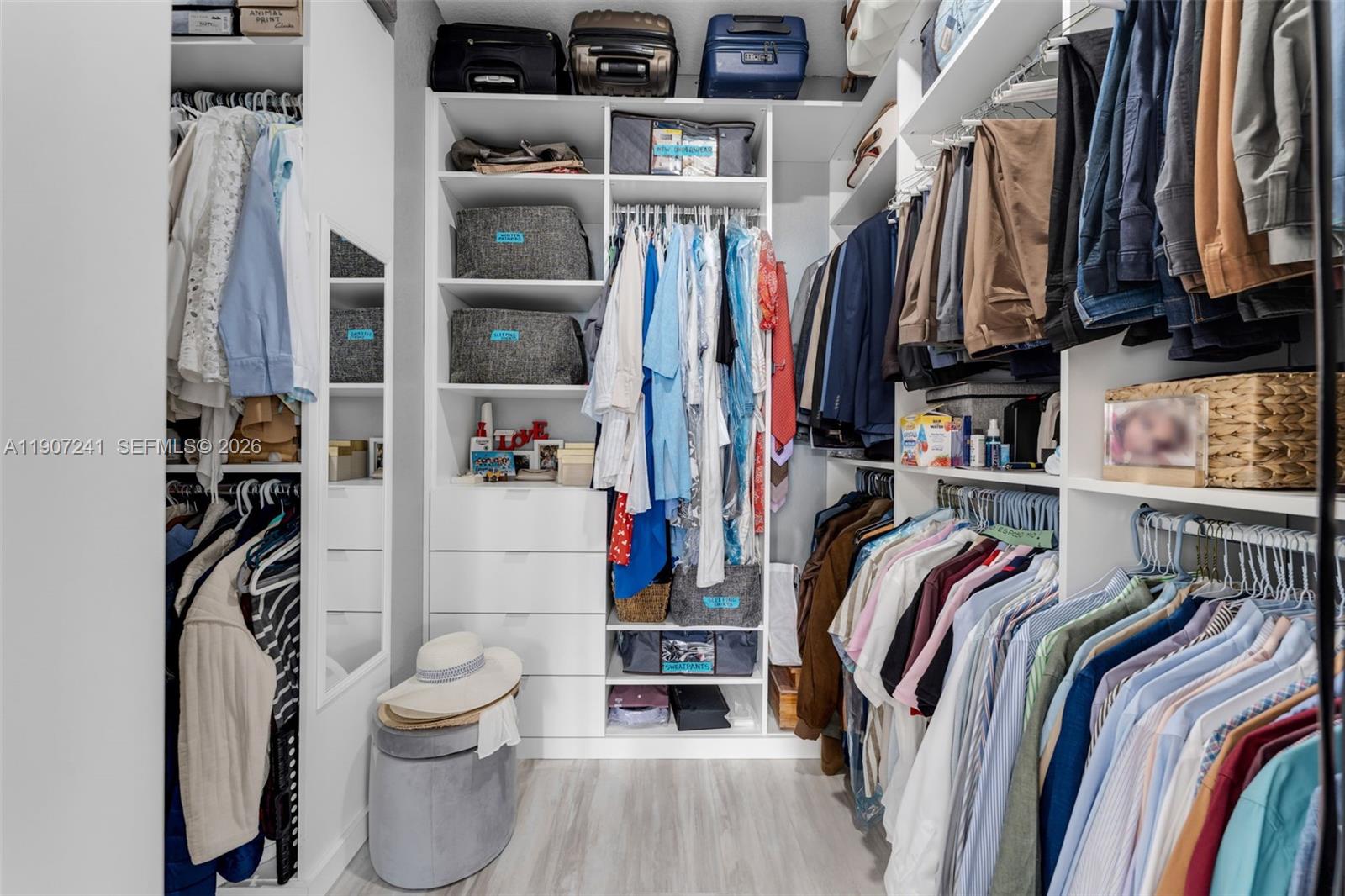 13240 Southwest 274th Street Homestead, FL 33032 - Photo 19 of 54 a view of walk in closet with clothes and shoes