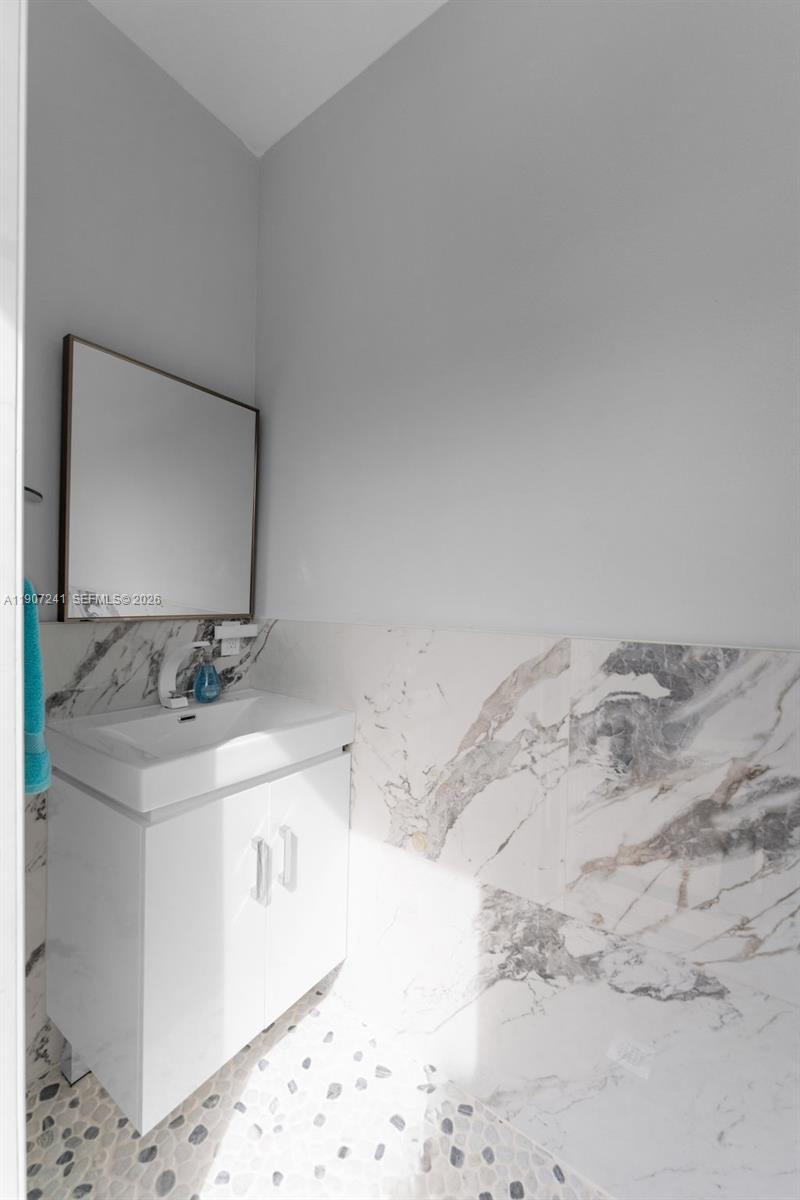 13240 Southwest 274th Street Homestead, FL 33032 - Photo 29 of 54 a bathroom with a sink and a mirror
