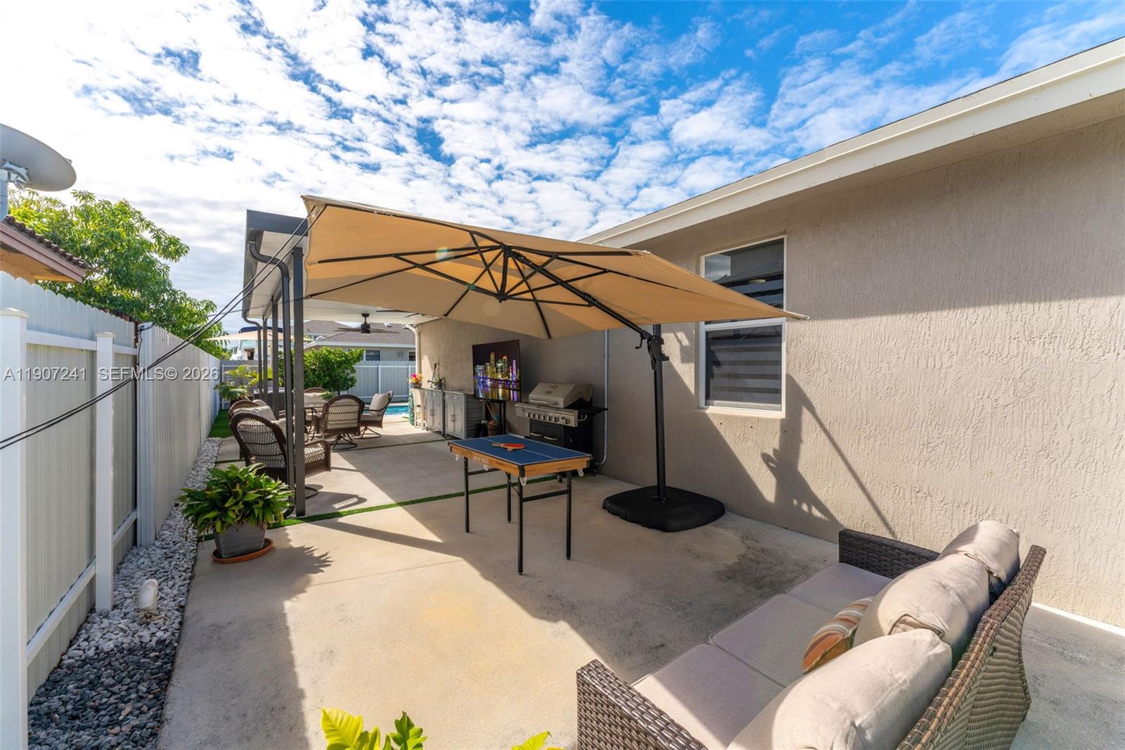 13240 Southwest 274th Street Homestead, FL 33032 - Photo 33 of 54 a backyard of a house with table and chairs