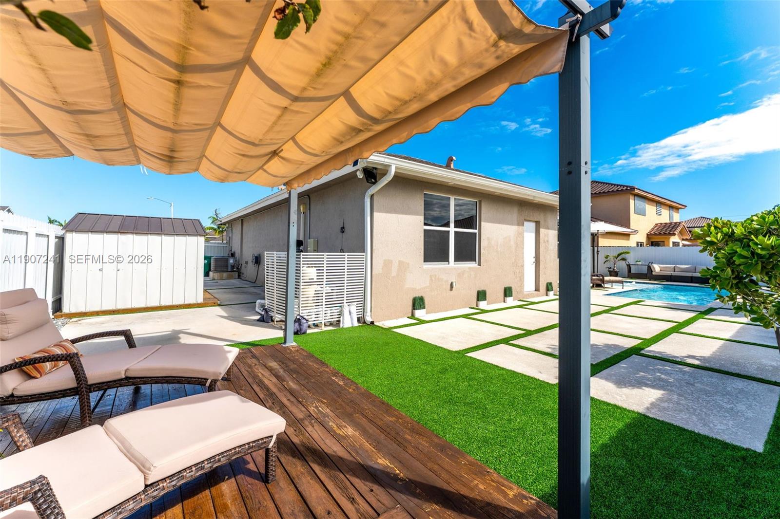 13240 Southwest 274th Street Homestead, FL 33032 - Photo 35 of 54 a view of a patio with table and chairs with wooden floor and fence