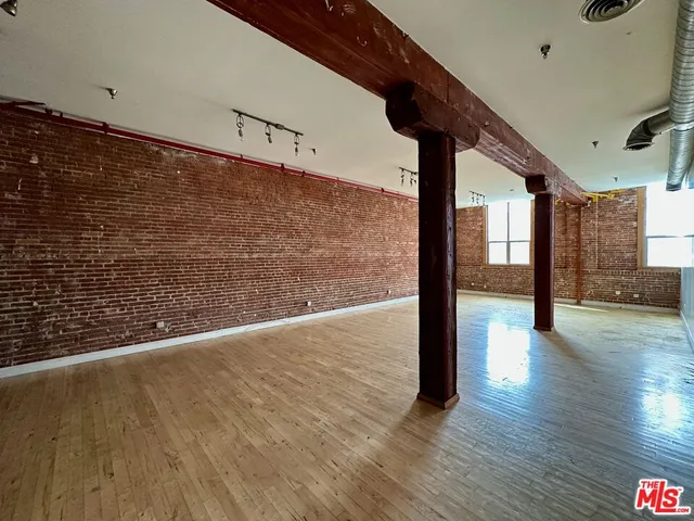 a view of water heater room with wooden floor